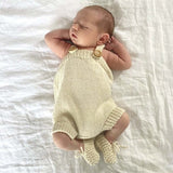 Baby in natural rompers and chunky booties