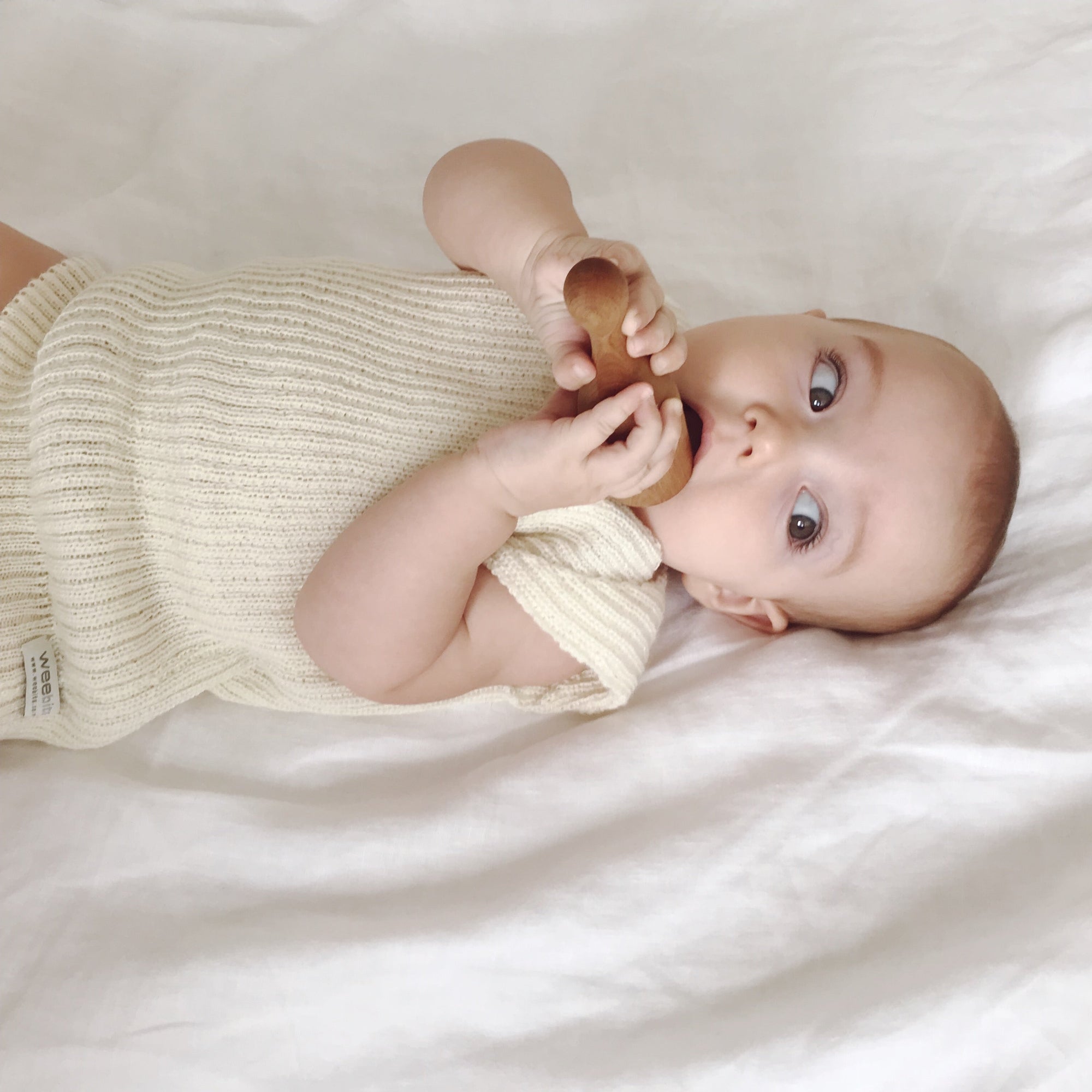 Baby wearing ivory singlet