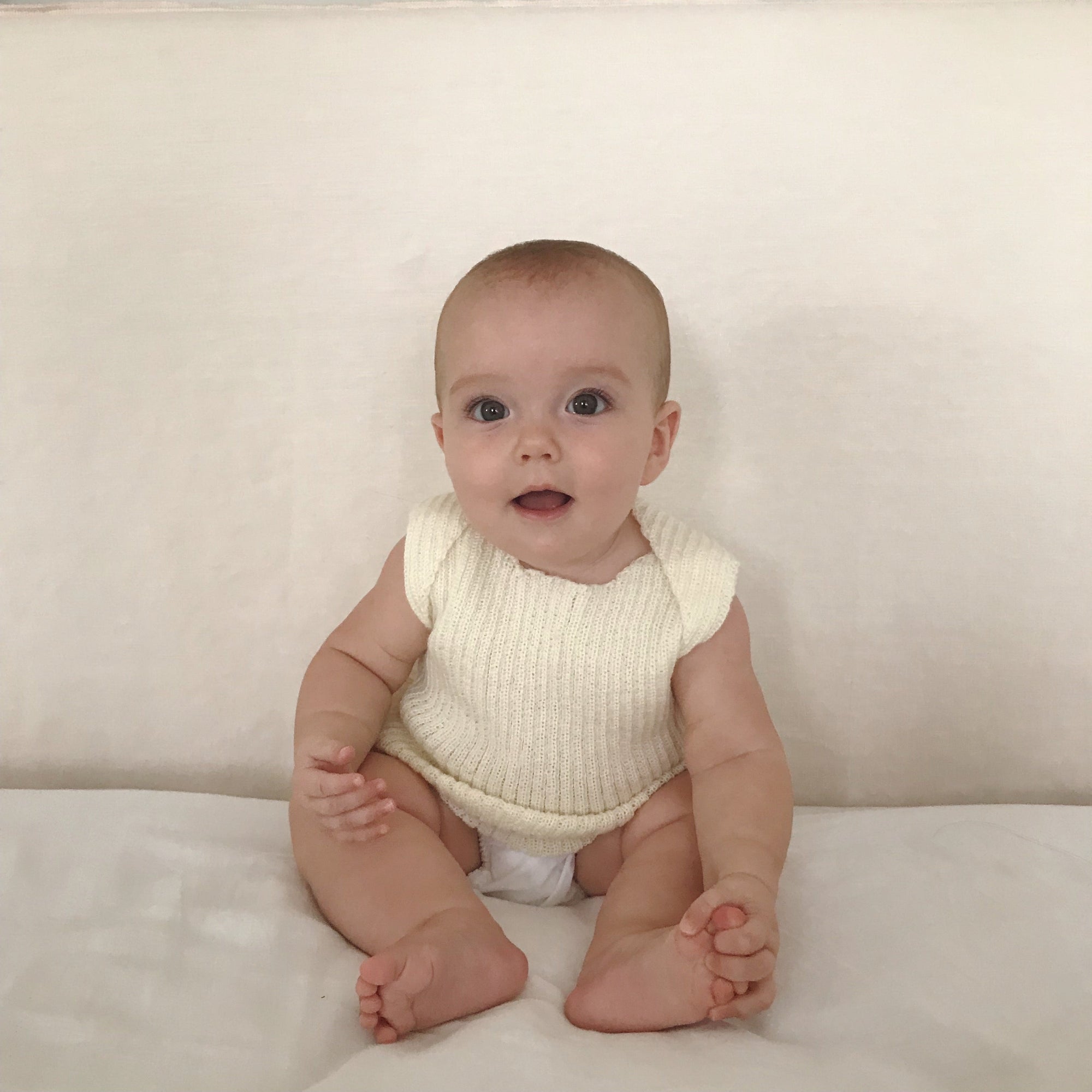 Baby wearing Ivory baby singlet