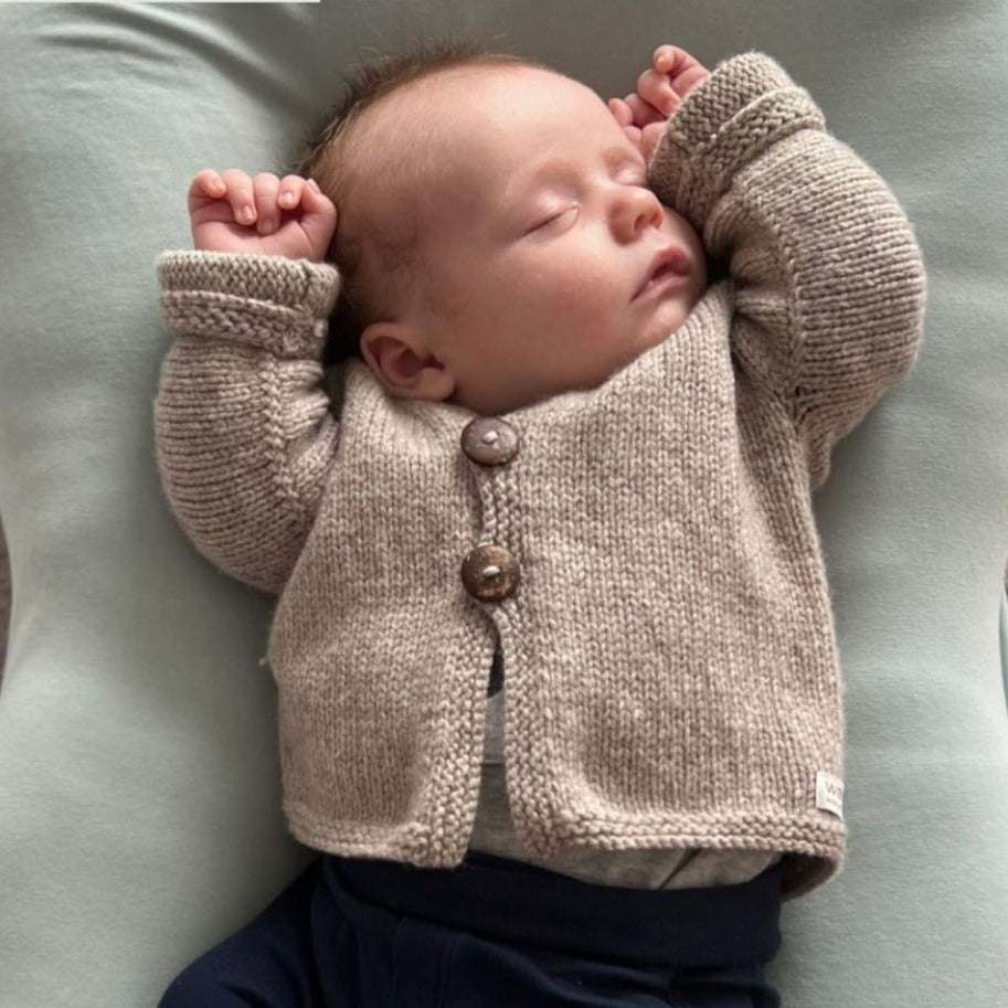 Baby wearing oatmeal baby cardigan