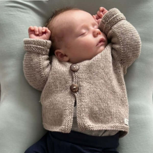 Baby wearing oatmeal baby cardigan