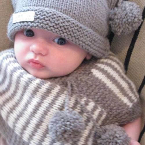Boy wearing mushroom baby pompom hat