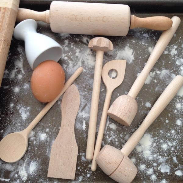 Childrens toy wooden cooking set on bench
