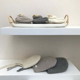 Chunky knit hats and boots on shelf