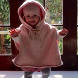 Girl in pink baby cape