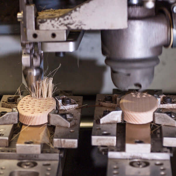 natural bristles being put in pet massage brush