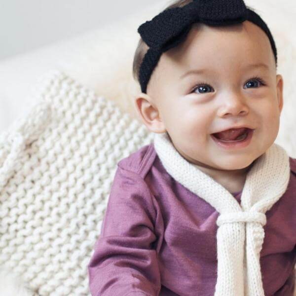 Infant wearing natural loop scarf