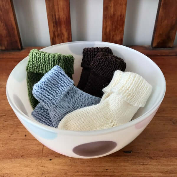 Merino baby socks in bowl