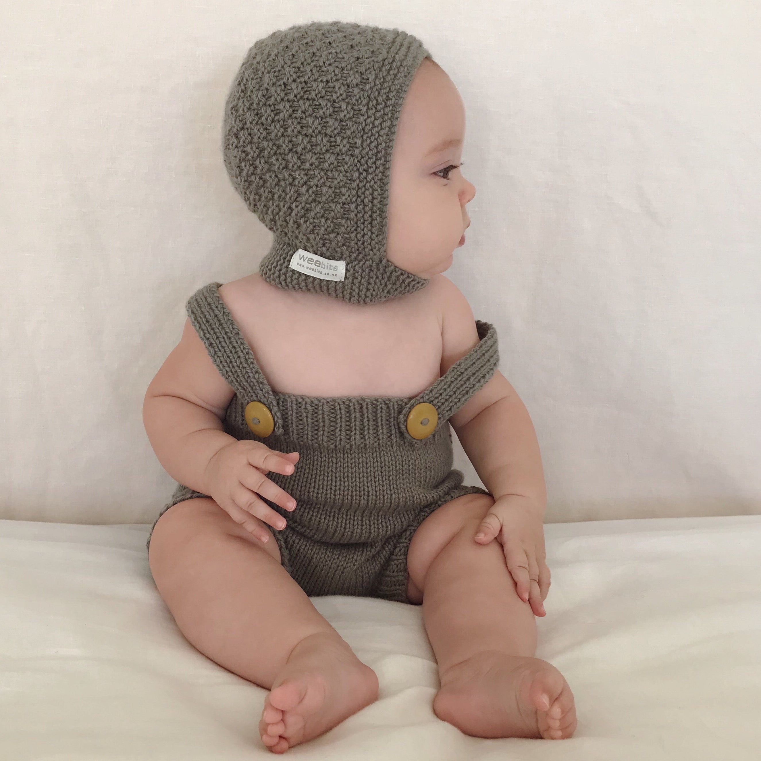 Mushroom side view of baby wearing newborn bonnet