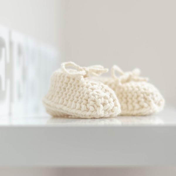 Natural chunky knit booties on shelf