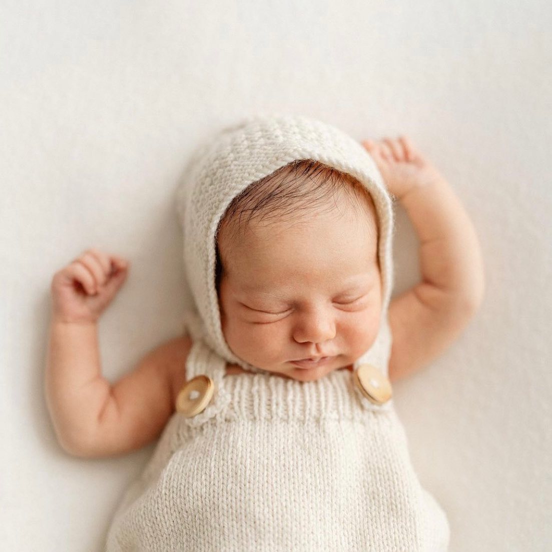 baby wearing natural knitted newborn bonnet