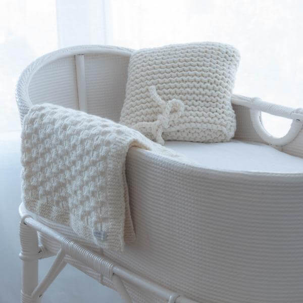 Natural nursery cushion in cot