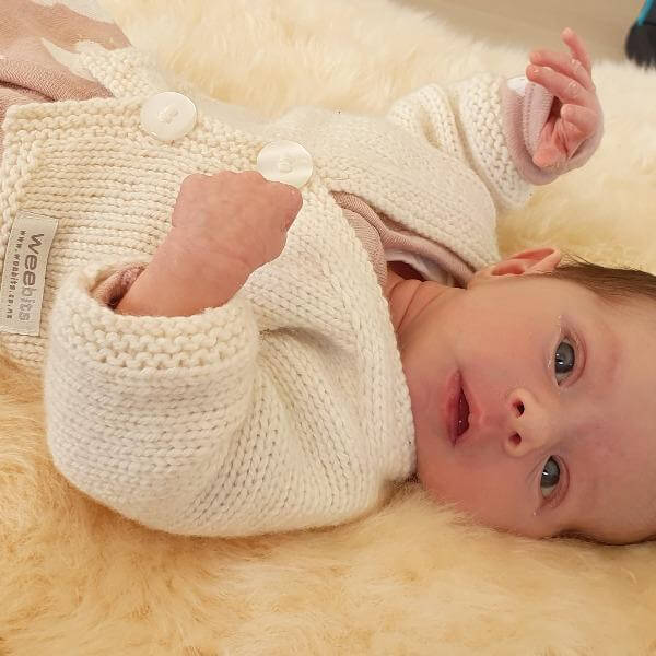 Newborn in natural premature cardigan