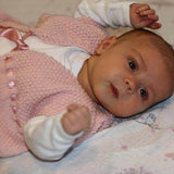 Newborn in pink baby waistcoat