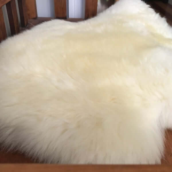 Off-white sheepskin play rug