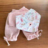 Pink knitted baby pants with matching dribble bibs