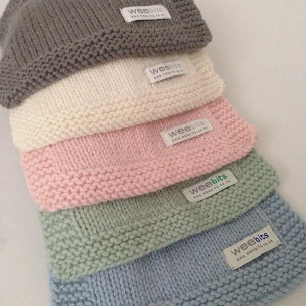 selection of baby bibs in a row with the label weebits attached at the front