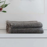 Solid grey stansborough cot blankets on shelf