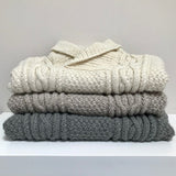 Stack of baby Aran jumpers