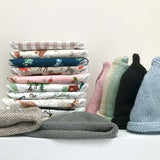 stack of dribble bibs and beanies