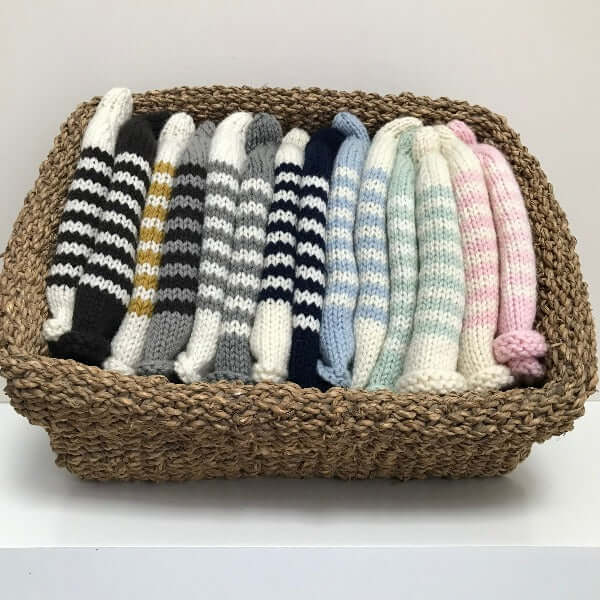 Stack of striped baby beanies