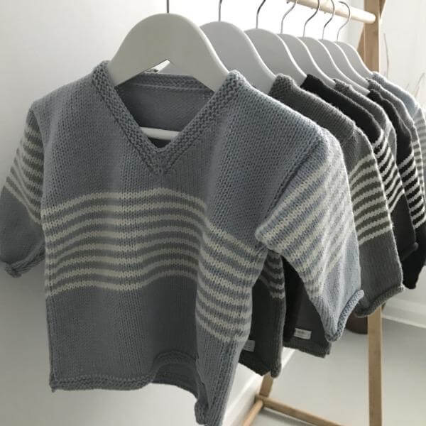 Striped baby pullovers on hangers